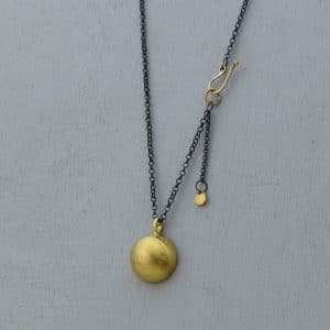 Dome 22k gold pendant on silver chain